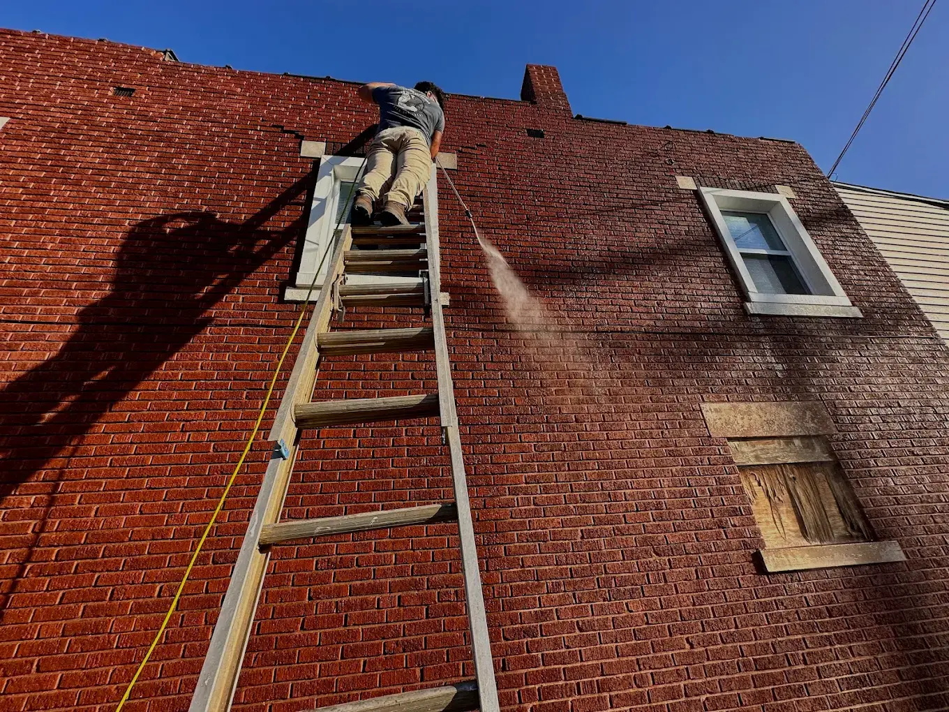 Power washing a concrete retaining wall